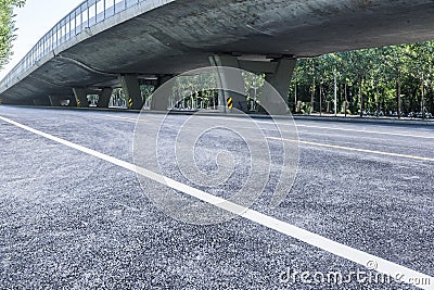 Asphalt roads and city buildings under the overpass, automobile advertising road material. Stock Photo